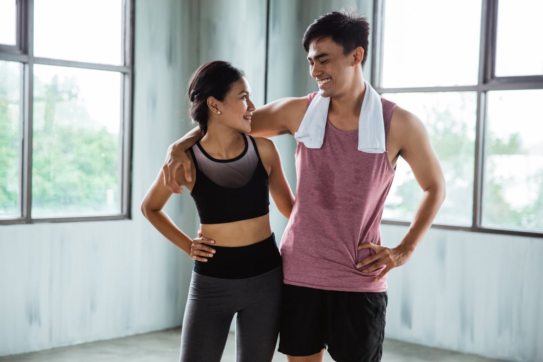 Asian Couple Sport Laughing during Exercise Break